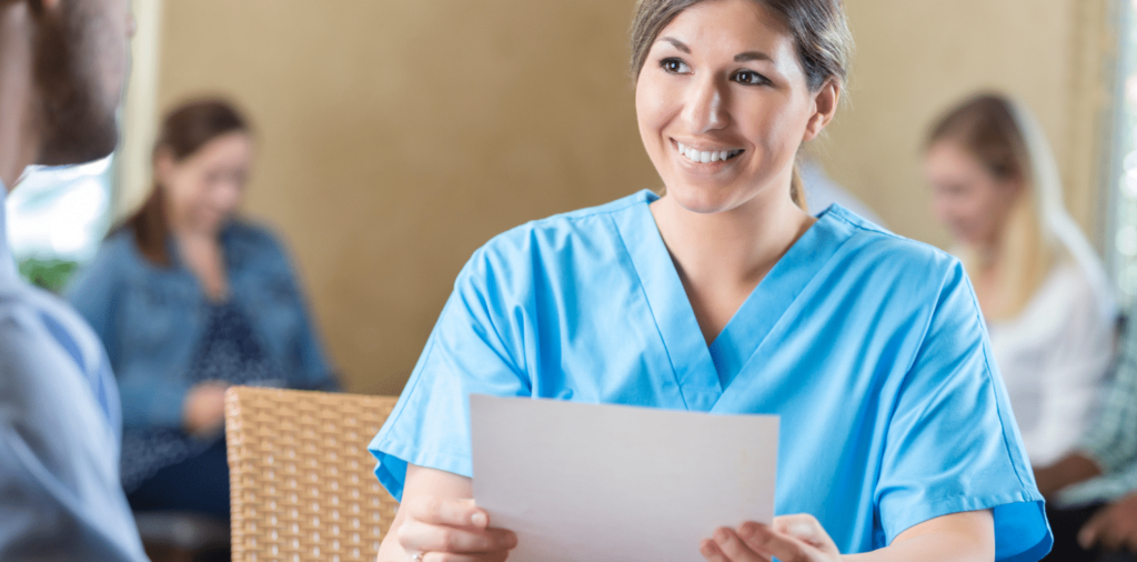 Nurse dressed in scrubs and holding her resume, ready to market herself during a travel nurse interview. She appears to be confident and focused, with a smile on her face as she prepares to showcase her skills and expertise.