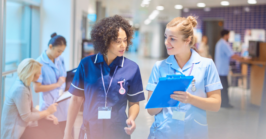 A senior staff nurse and a travel nurse are collaborating closely, discussing patient care. The senior nurse provides guidance while the travel nurse brings fresh perspectives and adaptability to the healthcare team. This image reflects the teamwork and expertise that travel nurses contribute to medical settings. Blog: "What Does a Travel Nurse Do?"