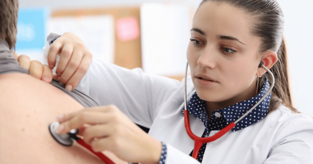 Respiratory therapist using a red stethoscope to listen to a patient's lungs. Highlighting the remarkable work of Respiratory Therapists.