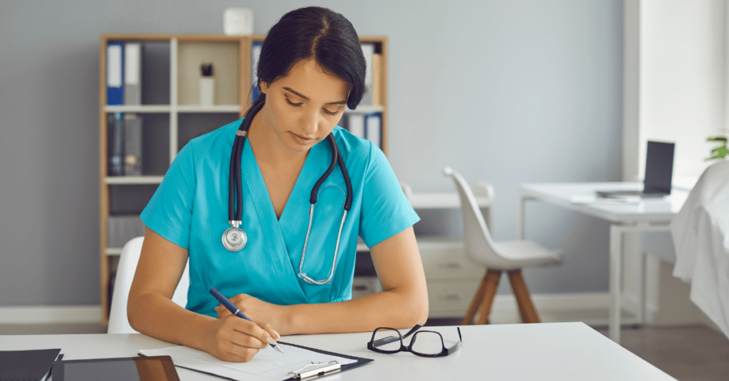 Image of a travel nurse sitting at a desk, focused on filling out an application for travel nursing jobs with determination and dedication.