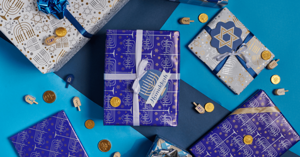 A table adorned with beautifully wrapped Hanukkah festival gifts, thoughtfully selected as Hanukkah gift ideas for nurses. The presents, wrapped in blue and silver paper, symbolizing the traditional colors of Hanukkah, are tastefully arranged to create an inviting and festive display.